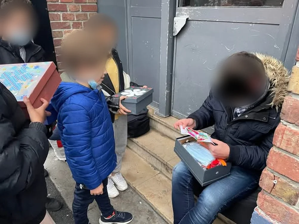 Des jeunes remettent des boîtes décorées lors d’une précédente maraude (visages floutés)